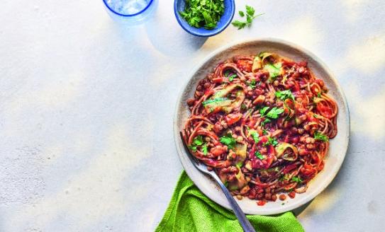 Bowl of lentil ragu on a white table